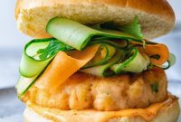Zesty Salmon Burgers Topped with Spicy Carrot-Cucumber Slaw