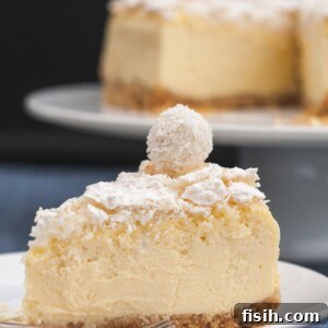 Slice of Raffaello cheesecake on a plate, garnished and ready to serve.