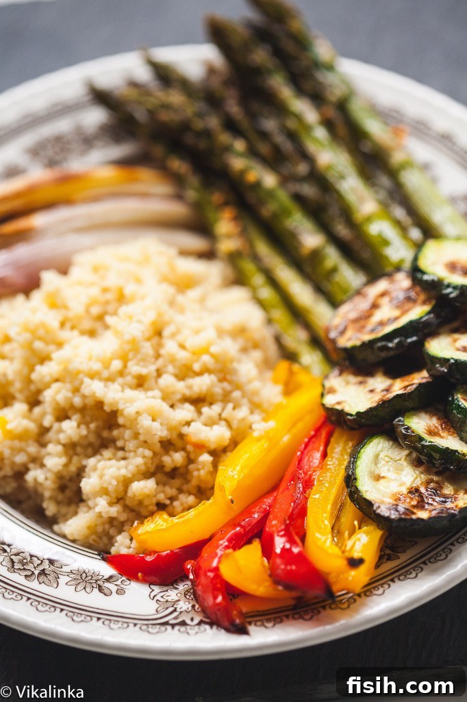 Moroccan Chicken and Roasted Veggie Couscous Bowl 5 Close up of the finished dish with roasted bell peppers and zucchini clearly visible, garnished with fresh herbs