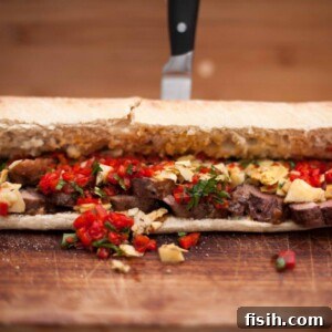 Close up of duck breast sandwich with knife in background