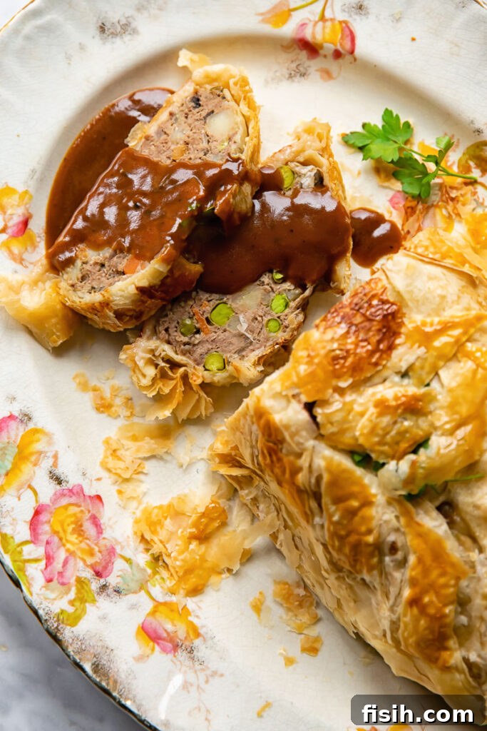 Rustic Ground Beef Wellington 5 serving platter with pieces of ground beef wellington with gravy