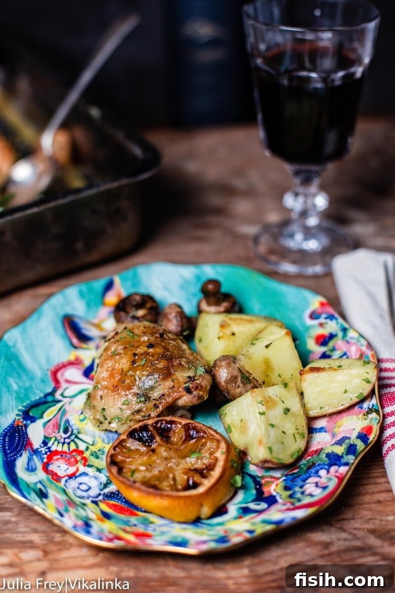 A vibrant platter of roasted Rosemary Lemon Chicken and Potatoes, garnished with fresh herbs and ready to be served.