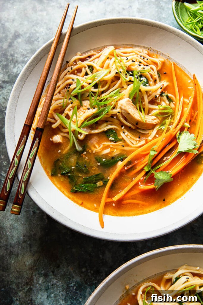 Authentic Thai Noodle Soup Made Easy 2 Delicious Thai Chicken Noodle Soup in a bowl with chopsticks, ready to be enjoyed.