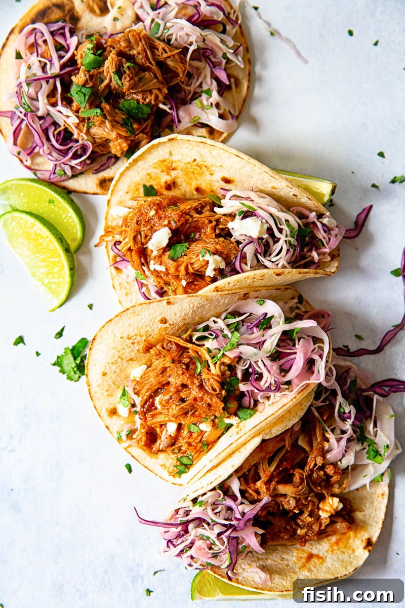 Melt-in-Your-Mouth Pulled Pork Tacos with Bright Cilantro Lime Slaw 4 4 soft tacos filled with pulled pork and red and white slaw