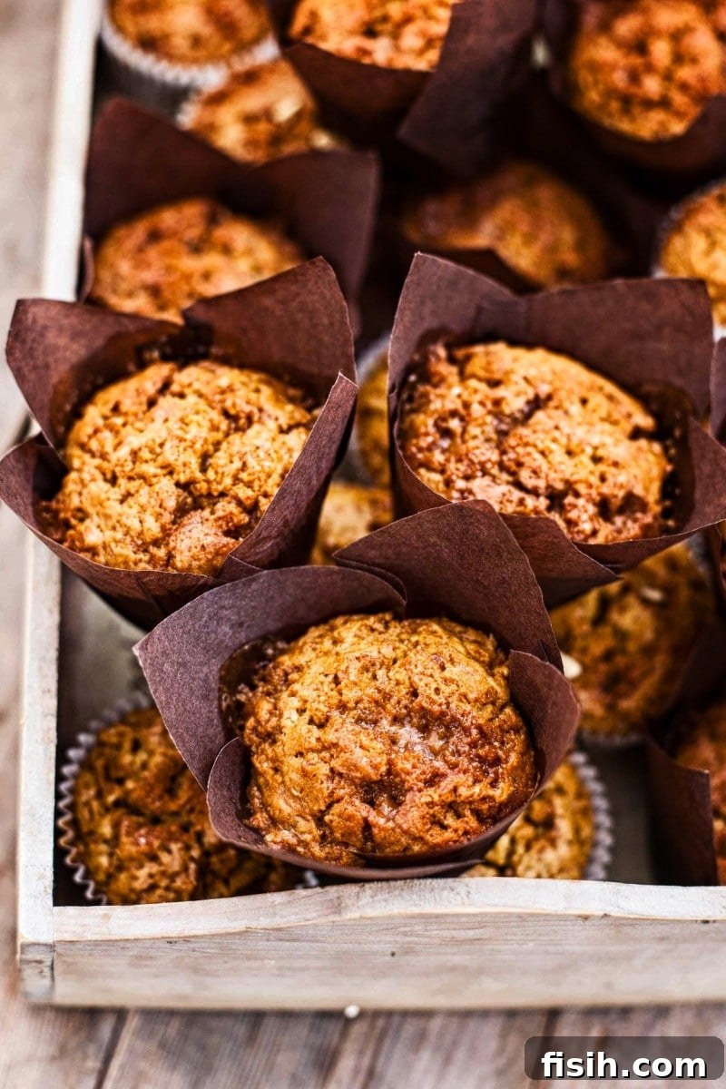 Golden Pumpkin Muffins with Toffee Honeycomb Crunch 2 Close up of Toffee Honeycomb Pumpkin Muffins showcasing their golden tops and crunchy topping.