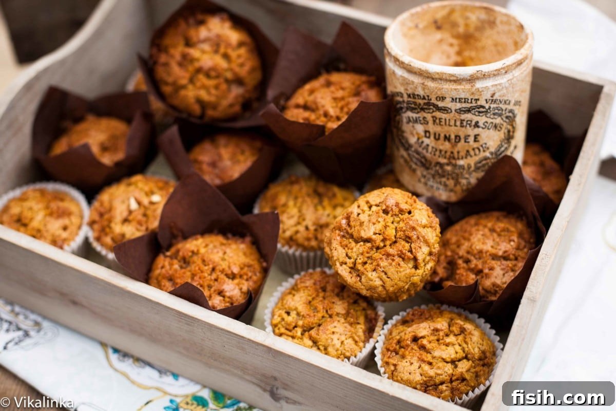 Golden Pumpkin Muffins with Toffee Honeycomb Crunch 3 Multiple toffee pumpkin muffins beautifully arranged in a rustic wooden box, with a jar of golden toffee in the background.
