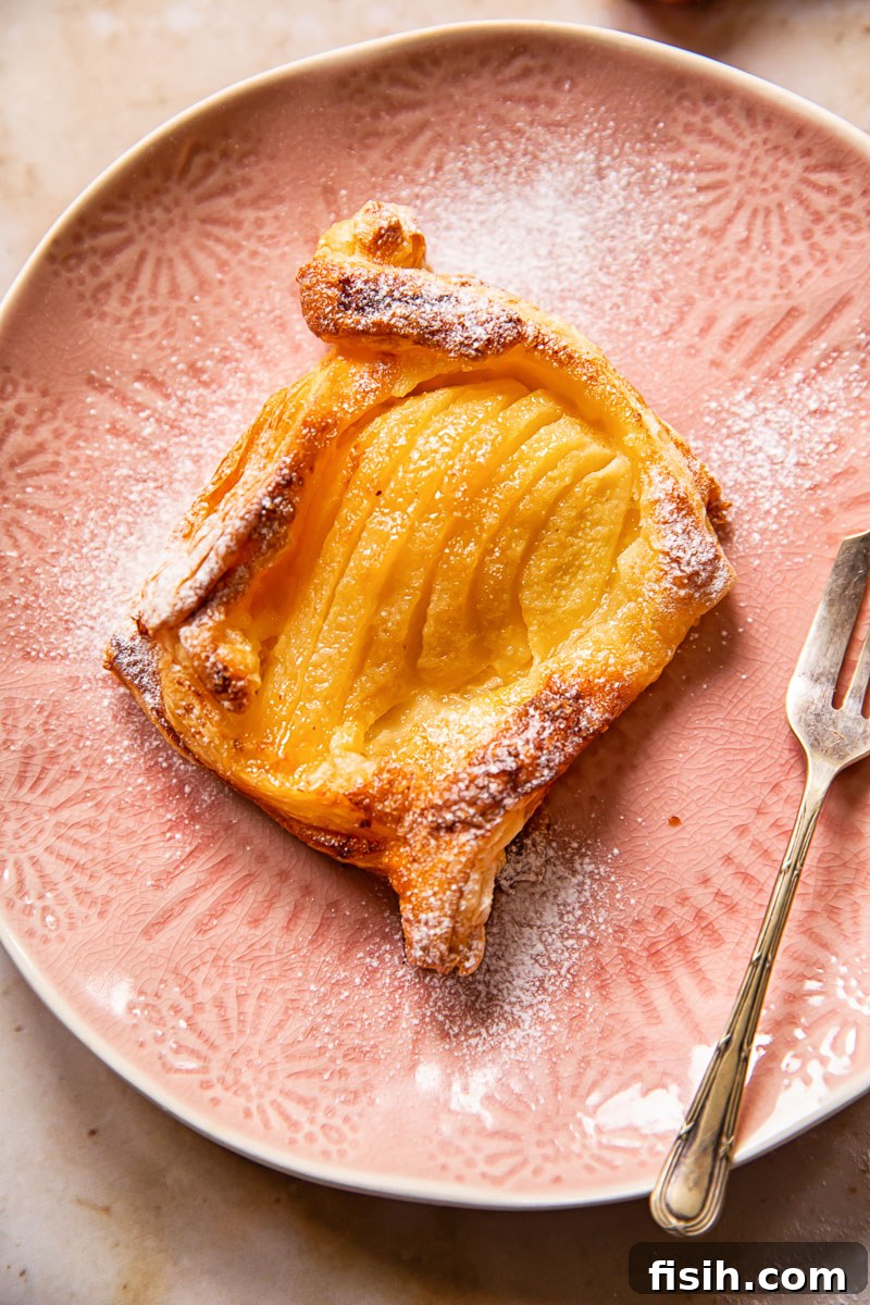close up view of a pear tart with golden pastry