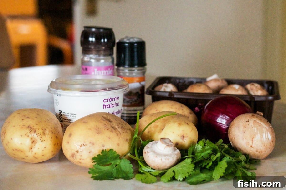 A collection of fresh ingredients laid out: potatoes, sliced mushrooms, fragrant herbs, and an array of spices, ready for the layered potato bake.