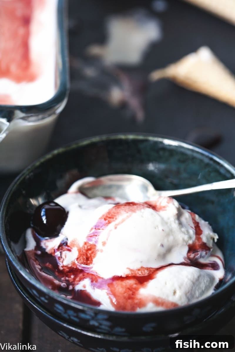 Velvety No-Churn Amarena Gelato 3 Scoop of Amarena Gelato in a bowl with a spoon, highlighting its creamy texture