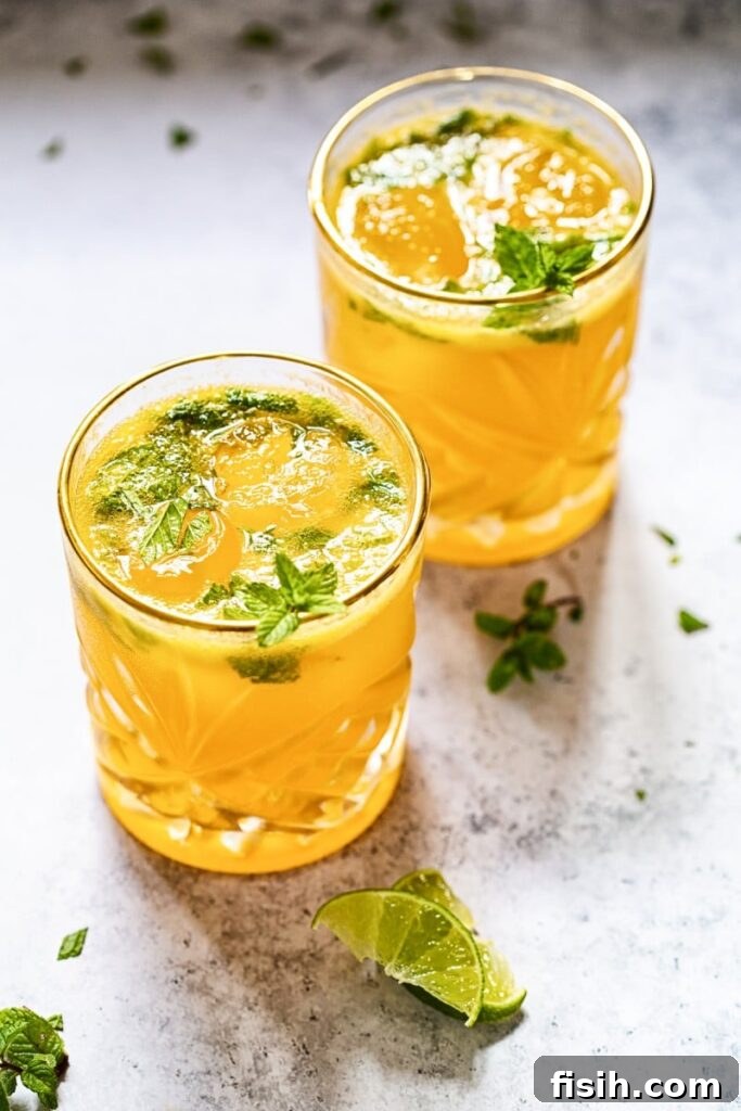 Vibrant Mango Mojito garnished with mint and lime, perfect for summer.