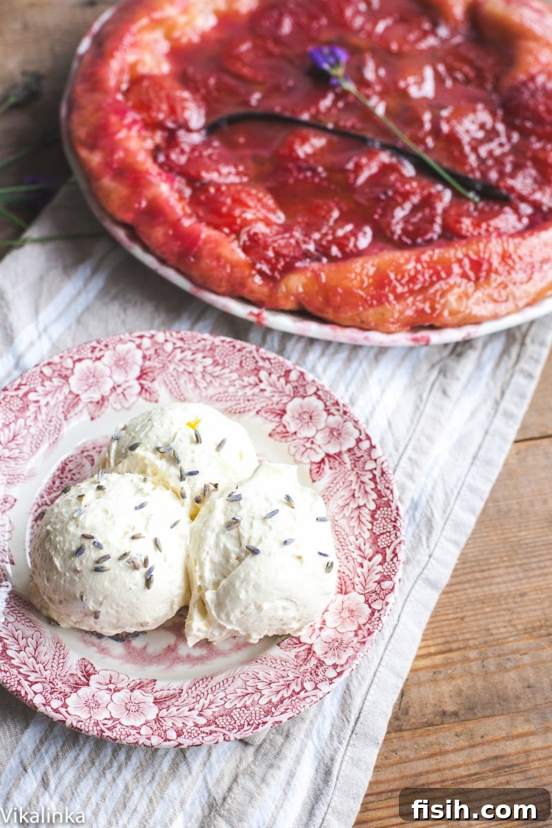 3 scoops of whipped cream sprinkled with lavender, tarte tatin in the background