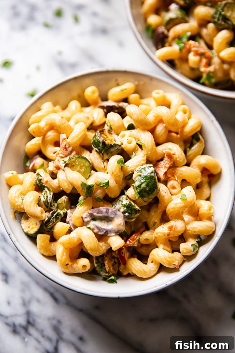 Top-down view of a generously portioned bowl of creamy zucchini pasta