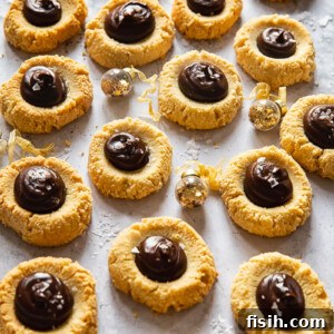 thumbprint cookies with chocolate on light background