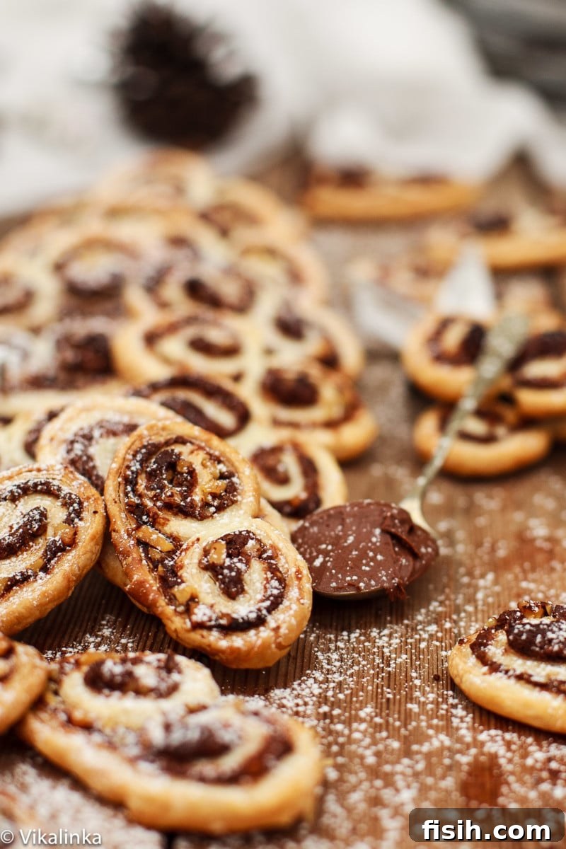 Nutella Swirled Hazelnut Palmiers 4 Close-up shot of individual Nutella Hazelnut Palmiers, showing their golden-brown, crispy edges and the rich, swirled chocolate-hazelnut filling.