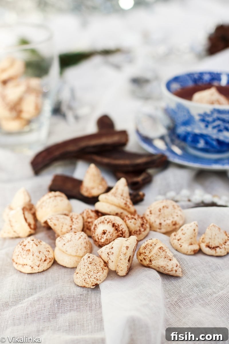 Close-up of a steaming cup of Italian Hot Chocolate, with a delicate meringue kiss floating on top, ready to melt.