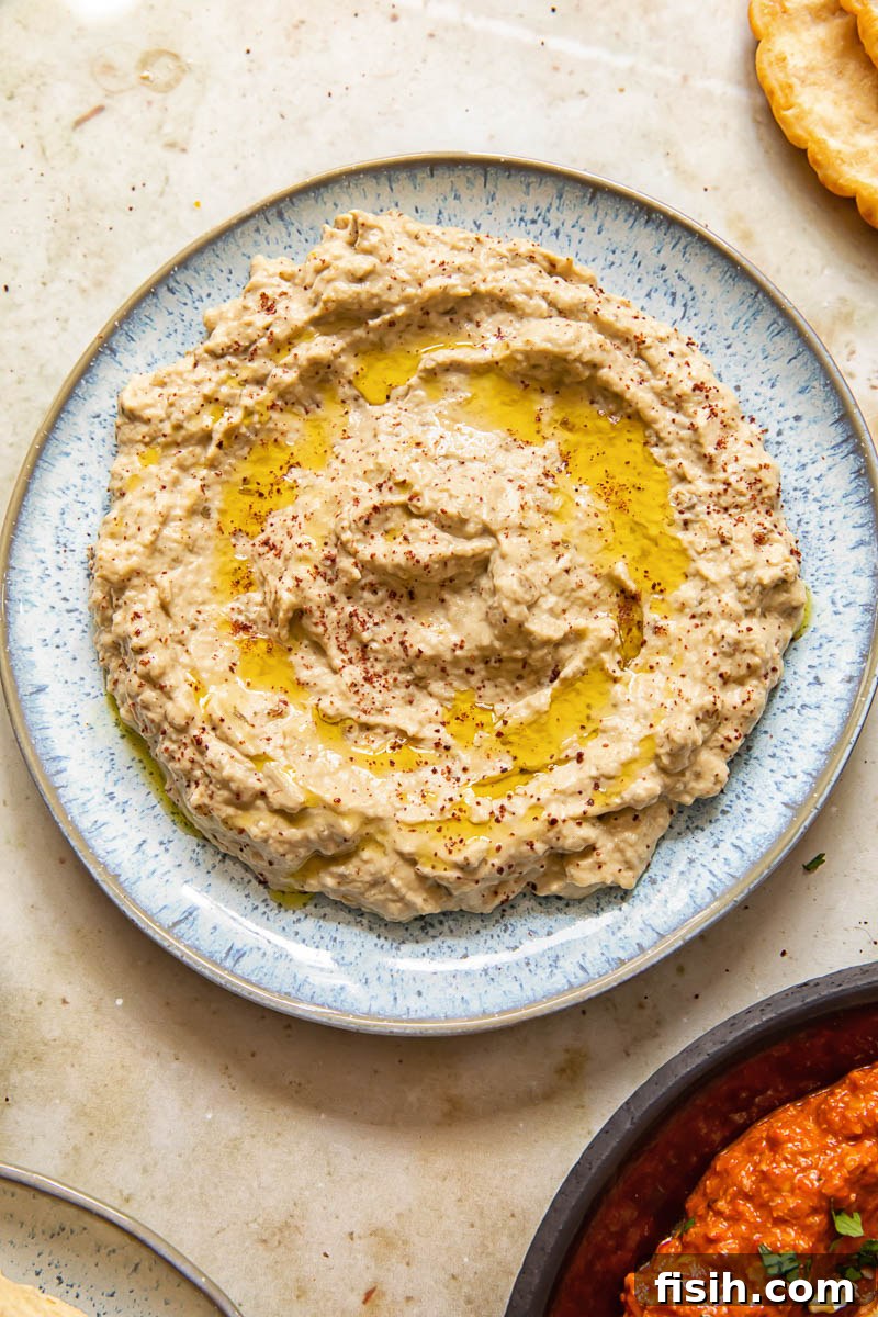 eggplant and tahini spread on a blue plate