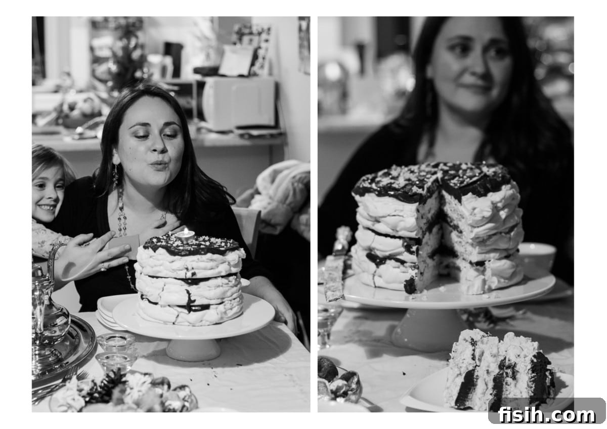 A woman stands proudly behind a beautifully cut Meringue Mascarpone Cake, highlighting the perfect layers of the dessert she has meticulously created, ready to be enjoyed.