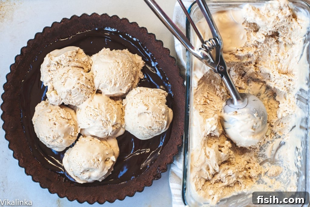 A scoop of creamy pumpkin spice latte ice cream in a dish, alongside two more scoops on a plate, ready to be enjoyed.