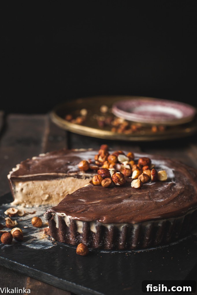 The finished Autumn Mississippi Mud Pie on a rustic wooden table, with a serving removed to reveal its luscious layers.