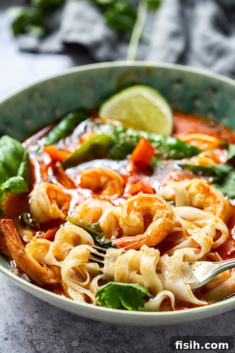 A vibrant bowl of Thai Red Curry with Prawns and Snow Peas, perfectly garnished and ready to be served over rice or noodles.