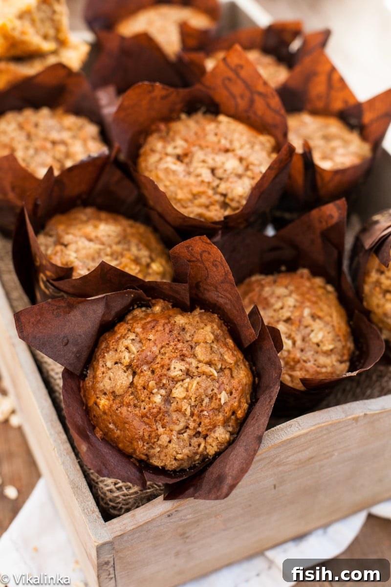 Freshly baked carrot oatmeal muffins in a rustic bread box, ready to be enjoyed.