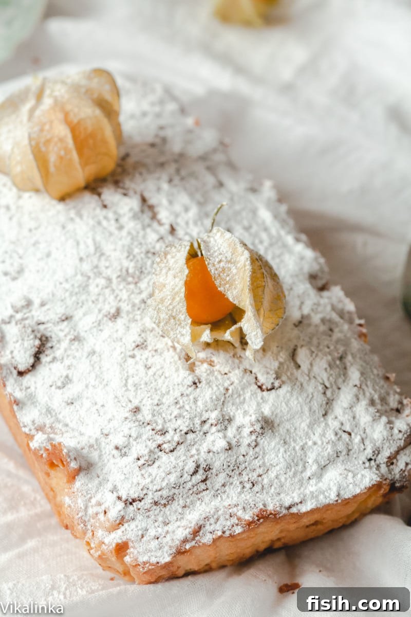Moscow Classic Pound Cake 3 A top-down view of a whole Russian Pound Cake, elegantly dusted with icing sugar, ready for slicing and serving.