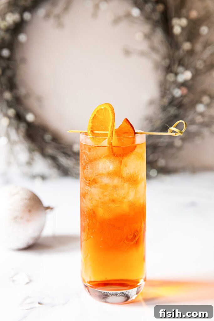Negroni fizz on a table with wreath in the background