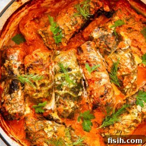cabbage rolls in creamy tomato sauce in orange pot