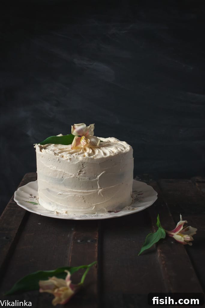 Spiced Pumpkin Chocolate Decadence with Mascarpone Creme 2 Side view of the pumpkin and chocolate cake against a dark background, showcasing its impressive layers and smooth frosting.