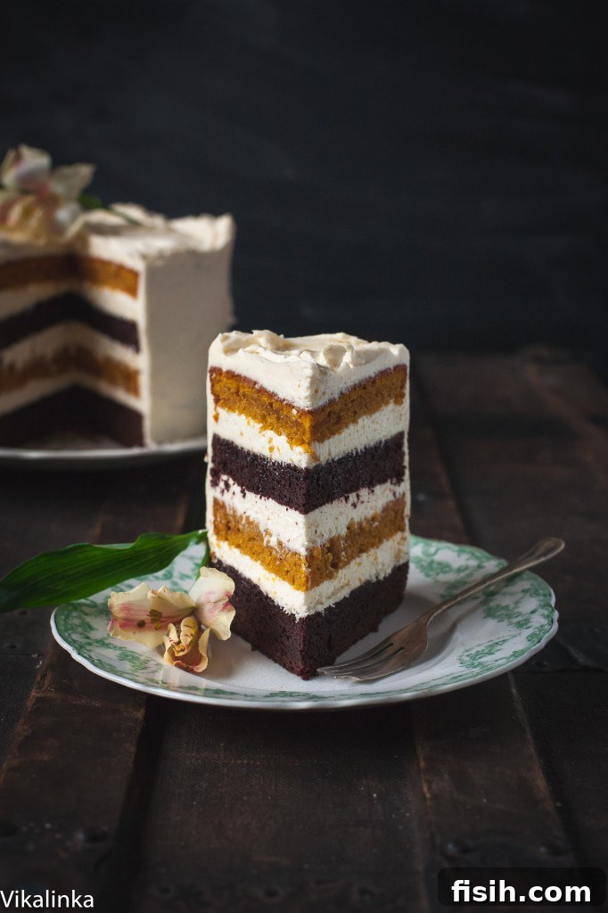 Spiced Pumpkin Chocolate Decadence with Mascarpone Creme 3 A perfectly cut slice of the cake, revealing the distinct layers of chocolate and pumpkin cake, separated by luscious frosting.