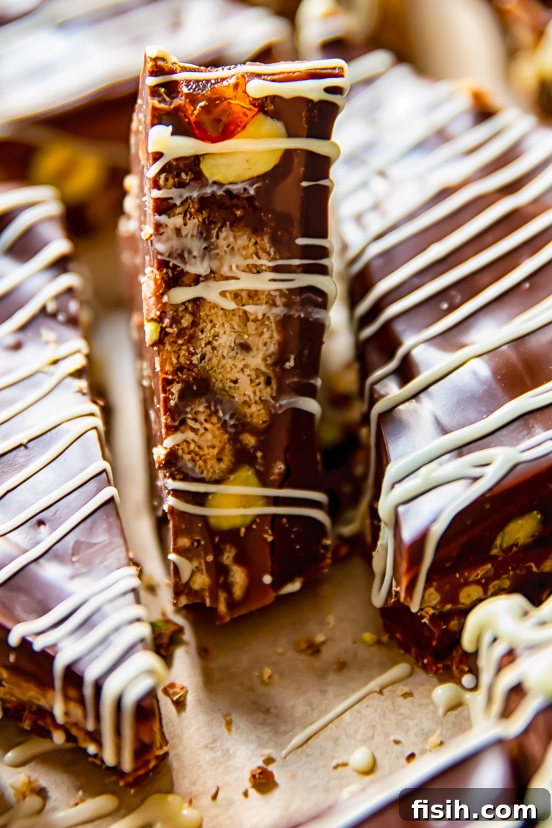 Close-up shot of a single chocolate fridge cake bar, revealing its intricate layers and textures.