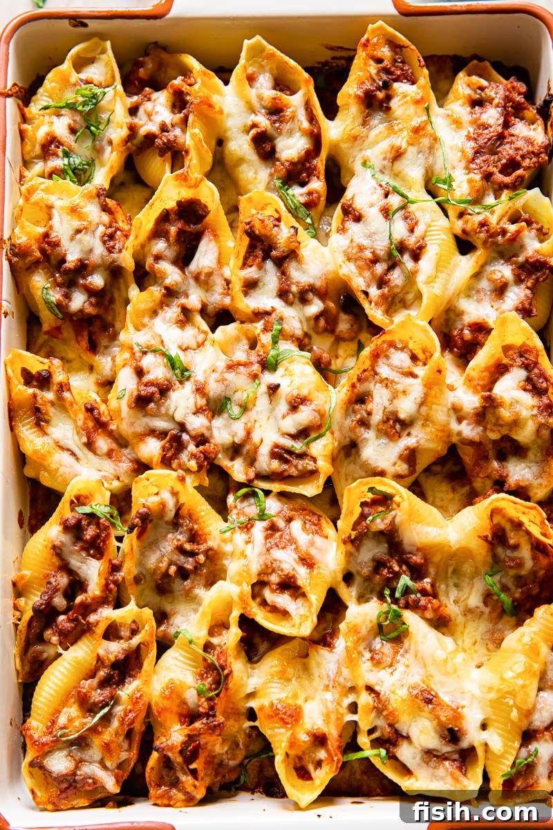 Quick Pesto Beef and Tomato Shells 2 Close-up of beef stuffed giant pasta shells topped with melted mozzarella cheese