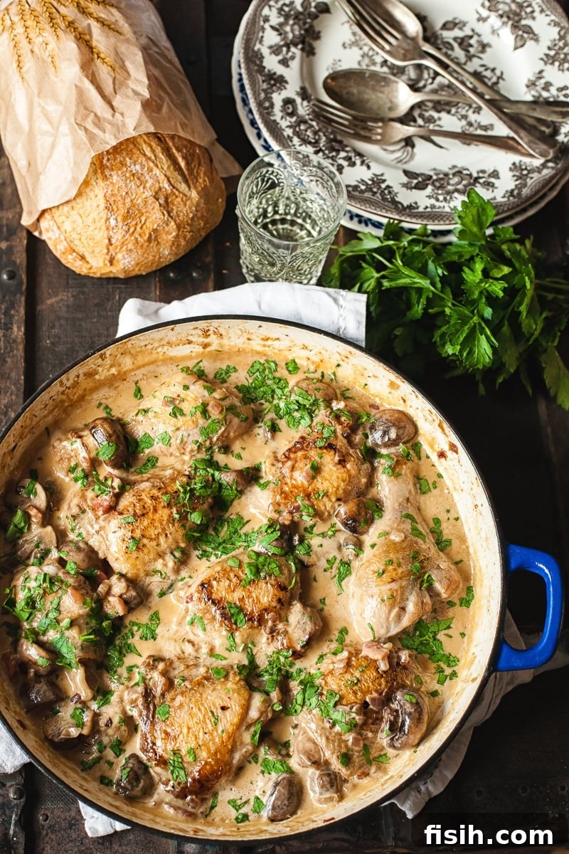 White Wine Braised Chicken 4 Top down view of Coq au Vin Blanc cooking in a pan, bubbling gently
