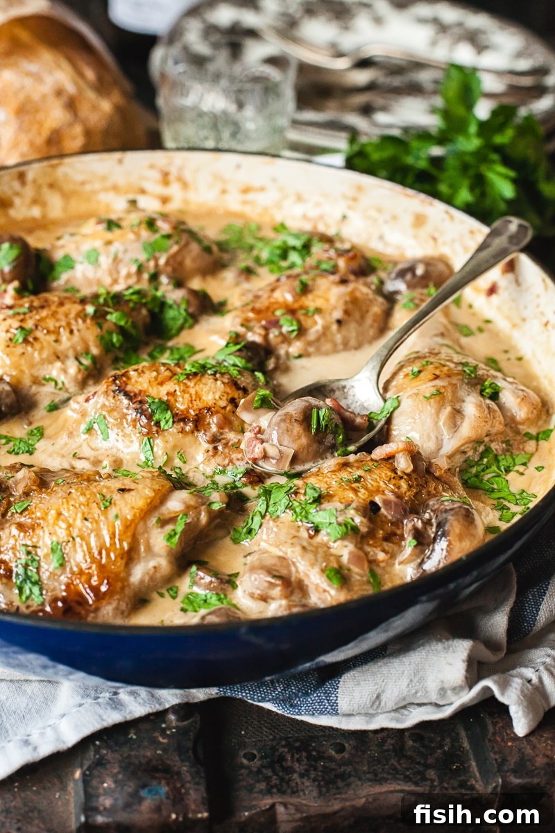 White Wine Braised Chicken 5 Coq au Vin Blanc in a pan with a serving spoon, ready to be dished out