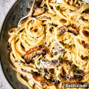Rich Truffle Cream Tagliatelle with Crispy Bacon and Forest Mushrooms 6 tagliatelle with mushrooms and bacon in a blue bowl with two forks in