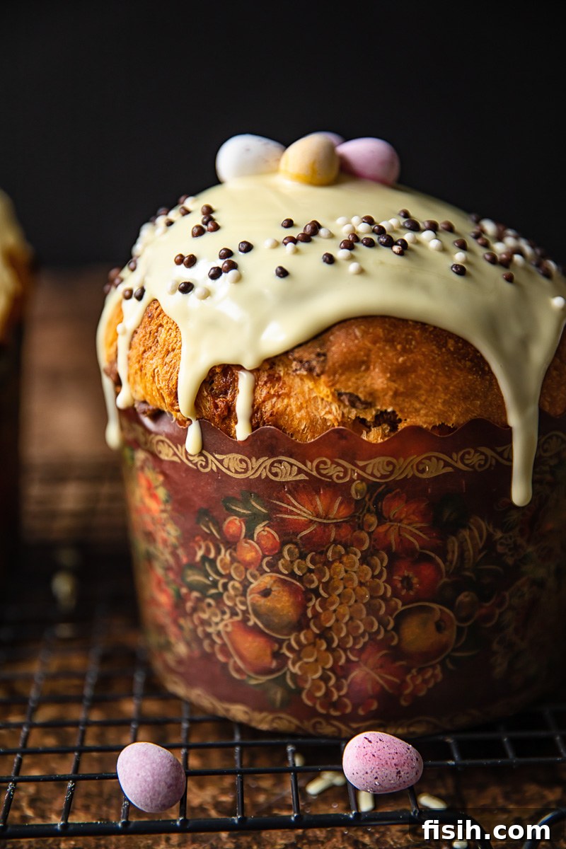 close up of kulich glazed with white chocolate and sprinkles