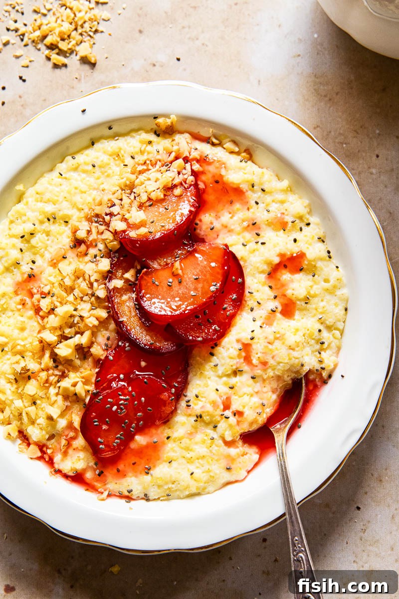Honey-Glazed Plum & Millet Delight 2 millet porridge in white bowl topped with cooked plums, walnut and chia seeds