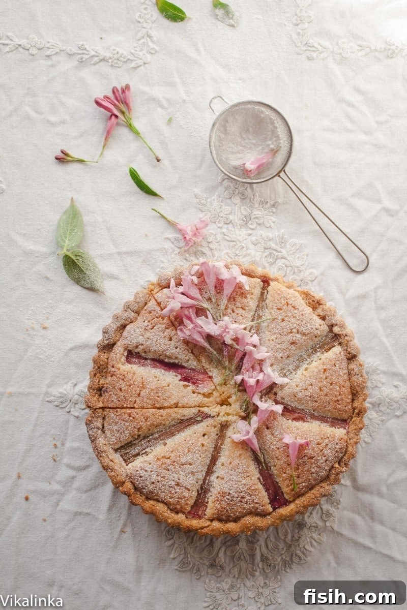 Rhubarb Bakewell Tart decorated with pink flowers