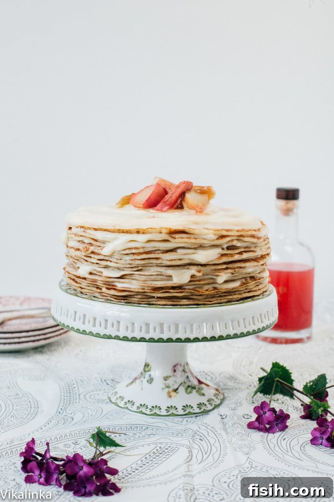 Rhubarb Custard Mille Crêpe Dream 2 Crepe cake with rhubarb pieces on top, showcasing the beautiful layers and vibrant topping.