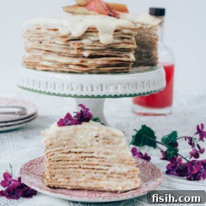 Rhubarb Custard Mille Crêpe Dream 6 A close-up of a slice of Rhubarb Custard Crepe Cake, showing the layers of crepes and filling.