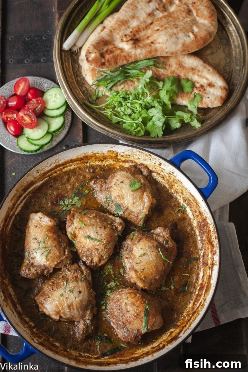 Top down of chicken in garlic walnut sauce in a pan