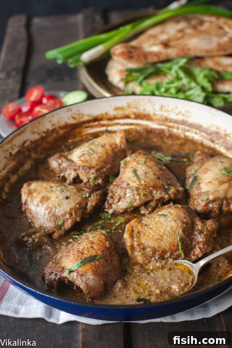 Close up of chicken in garlic walnut sauce