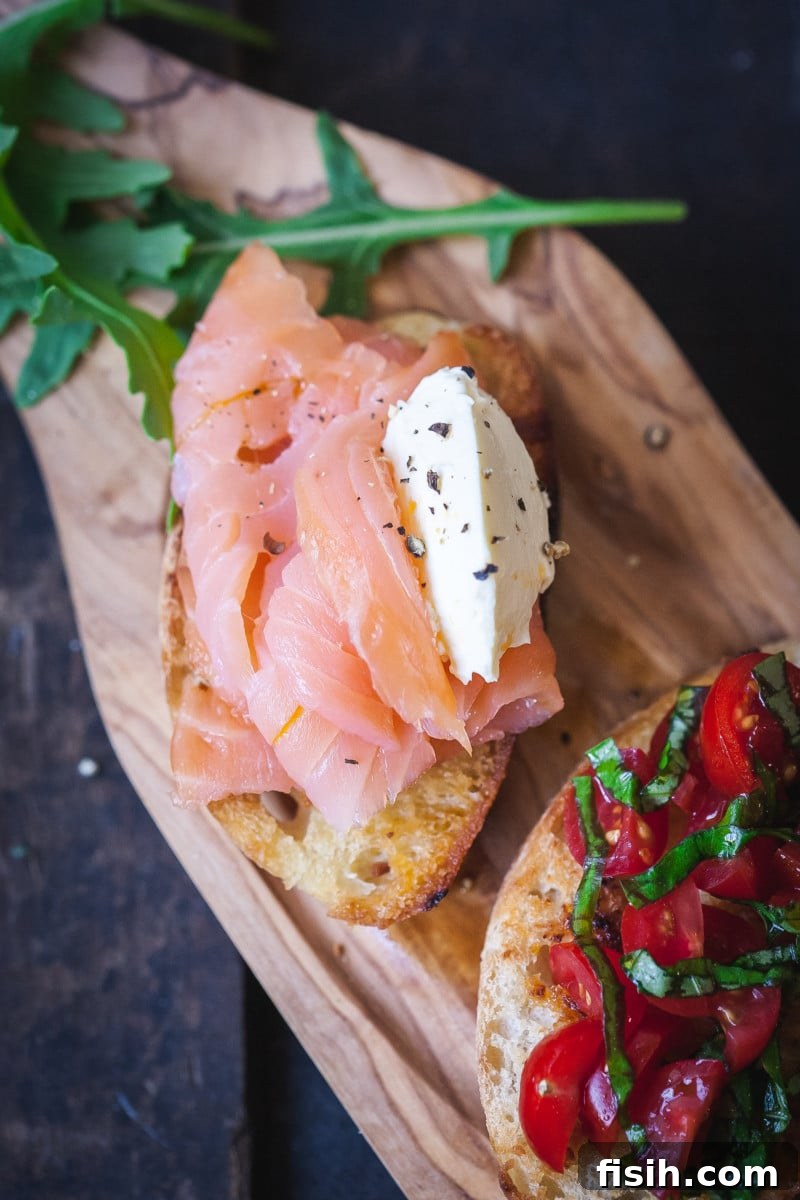 Crostini Quartet: Four Party-Ready Bites 7 Elegant crostini topped with smoked salmon and a dollop of creamy whipped cream, ready to be served.