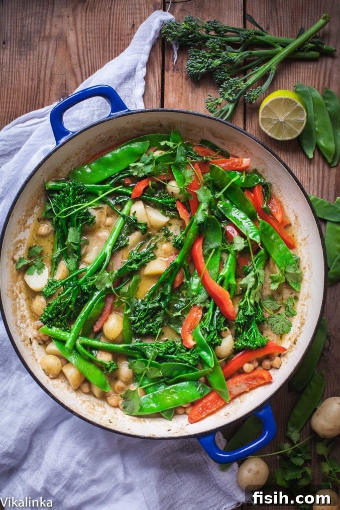 Close-up of Green Vegetable, Young Potato and Chickpea Thai Curry in a bowl, showcasing fresh ingredients.