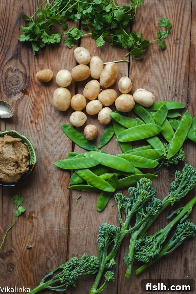 A bowl of fresh Vegetarian Thai Green Curry with New Potatoes, Snow Peas, Chickpeas, and Broccoli, garnished with fresh cilantro.