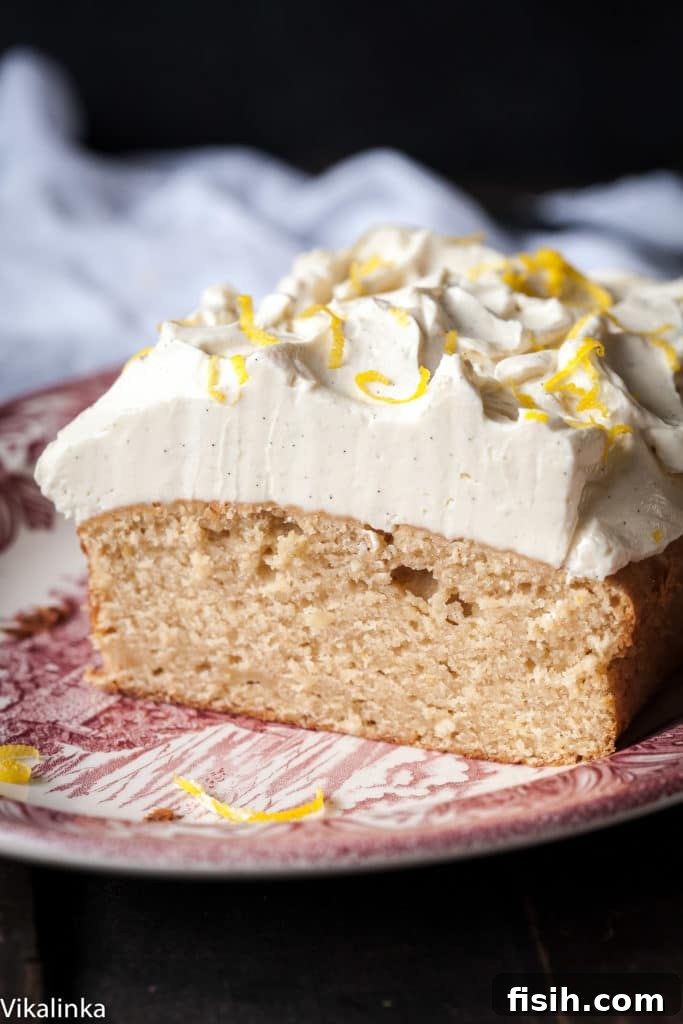 Zesty Lemon Ricotta Cloud Cake with Tangy Cream Cheese Frosting 3 Close-up side view of a sliced lemon ricotta cake, revealing its perfectly moist, soft, and tender crumb, highlighting the beautiful texture achieved with ricotta cheese.