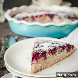 A slice of Wild Blackberry Tea Cake on a plate, highlighting the fruit and tender texture.