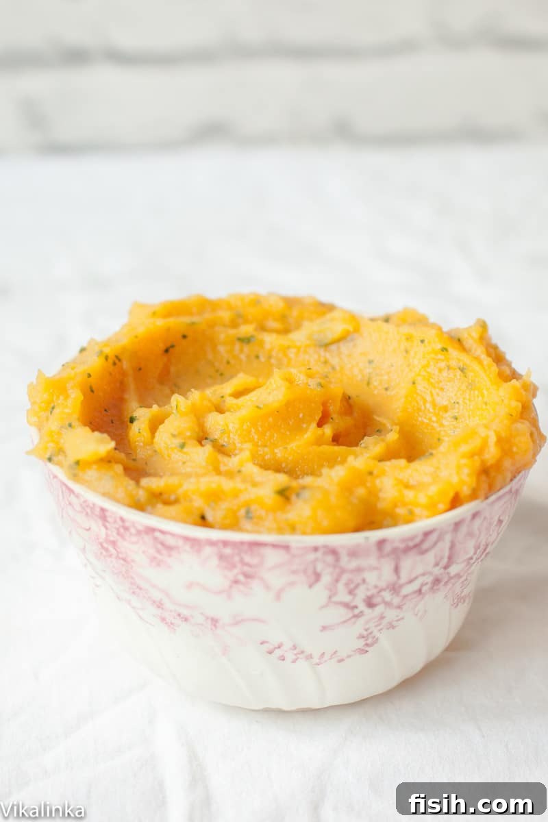 A close-up shot of the creamy texture of sweet potato and swede mash, highlighting its vibrant color.