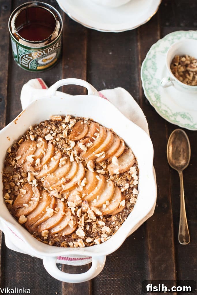 Serving of Spiced Pear Baked Oatmeal drizzled with syrup and walnuts