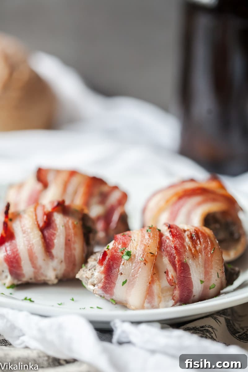 Gourmet Bacon Wrapped Chicken Thighs with Mushroom and Goat Cheese Filling 3 Close up shot of a bacon wrapped chicken thigh, highlighting the crispy bacon and moist chicken